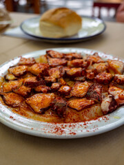 Tasty seafood, grilled octopus galician style with red pimento paprika and potatoes