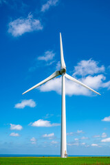 View on modern wind mills, green grain fields and blue Atlantic ocean in agricultural region Pays de Caux in Normandy, France