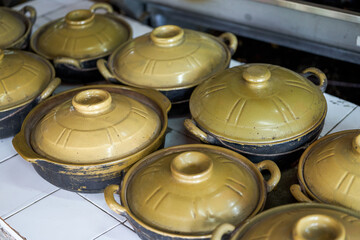Close-up of a pile of terracotta containers in the kitchen