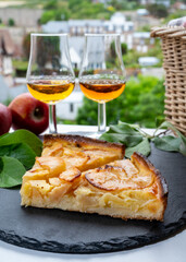Tasting of baked apple cake and strong alcoholic drink calvados made from apples in Normandy, Calvados region, France