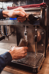 The work of a barista in a cafe close-up - the stages of preparing aromatic coffee - the process of work