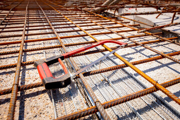 Metal cutting saw was putted on the square rusty armature which is placed to strengthen the bridge