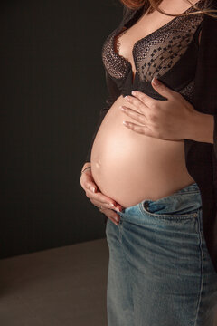 Pregnant Woman In Panties And A Heart-patterned Bra Is Standing Indoors  With A Potted Flower. Stock Photo, Picture and Royalty Free Image. Image  126882897.