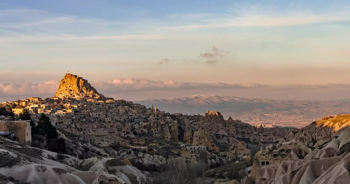 Day to night sunset timelapse of Turkish fortress Uchisar in the Cappadocia, Turkey. Zoom in.