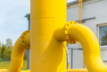 Two black and yellow gas pipes are connected by large bolts.Background for suppliers of gas products and pipes.Close-up,selective focus.