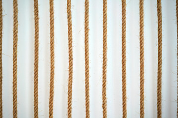 rope string vertical hang in front of wall