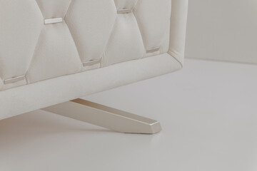 white handmade sofa on metal legs on a white background