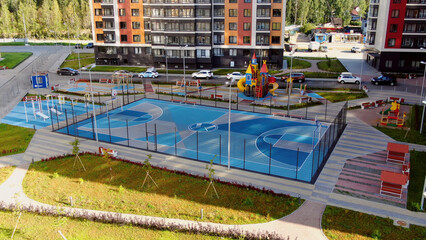 Fototapeta na wymiar Top view of beautiful modern Playground at residential complex. Motion. Design landscape of modern Playground with different colors and purposes