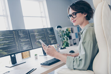 Photo of positive attractive lady sitting chair hold use telephone typing chatting workplace office