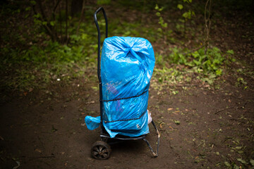 Cart with cargo. Forgotten bag. Blue package.