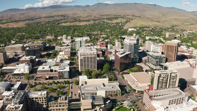 Wide drone shot of Boise, Idaho's downtown sector surrounded by arid farmland.