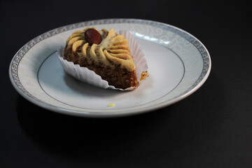 oriental sweets on a white plate black background