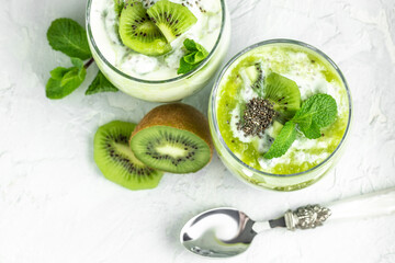 Fototapeta na wymiar Chia seed pudding made with lactose-free yogurt, kiwi and mint, Delicious breakfast or snack, banner, menu, recipe, place for text,