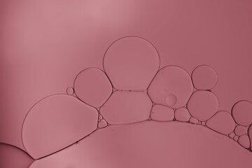 Oil bubble on pink gradient background.	