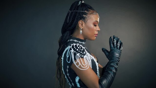 Fantasy portrait african american sexy woman queen priestess of night. tiara diadem crown silver moon head. Creative black dress. Voodoo girl pagan raised hands folded in prayer. halloween costume
