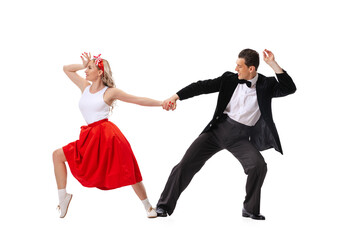 Astonished young man and woman in retro style outfits dancing lindy hop isolated on white...