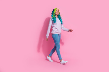 Obraz na płótnie Canvas Full body profile side picture of pretty girl go on walk look empty space enjoy nice weather isolated on pink color background