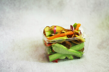 Food waste in container Close up. Organic garbage composting concept. Sustainable lifestyle. 