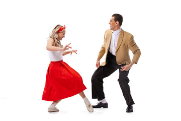 Expressive couple of dancers in vintage retro style outfits dancing social dance isolated on white background. Art, music, fashion, style concept