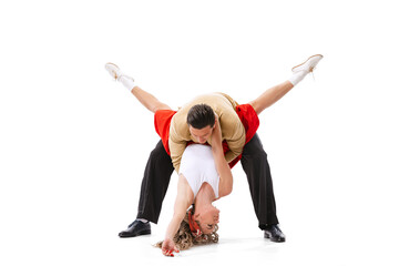 Astonished young man and woman in retro style outfits dancing lindy hop isolated on white...