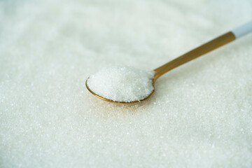Spoon with sugar on a white background	
