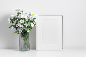 Blank white artwork frame mockup with chrysanthemums flowers bouquet