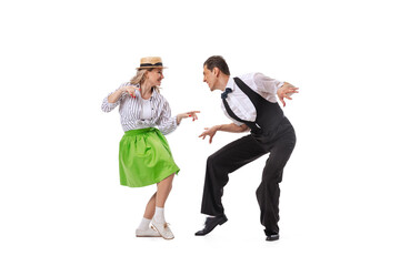 Excited young couple of dancers in vintage retro style outfits dancing social dance isolated on white background. Art, music, fashion, style concept