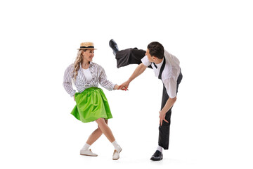 Astonished young man and woman in retro style outfits dancing lindy hop isolated on white background. Art, music, fashion, style concept