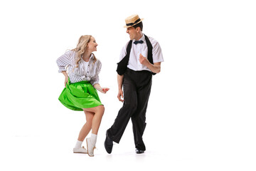 Astonished young man and woman in retro style outfits dancing lindy hop isolated on white background. Art, music, fashion, style concept