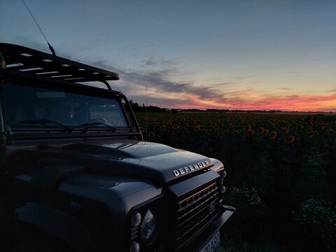 Road trip with a Land Rover Defender. Recreational travel activity. Sunset Safari 2022