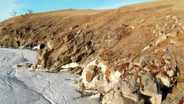 rocky coast of frozen lake in North, aerial view of amazing landscape, beauty of nature