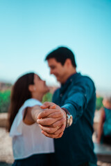 beautiful couple in love holding hands while smiling