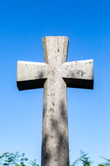 A stone cross on a gravestone