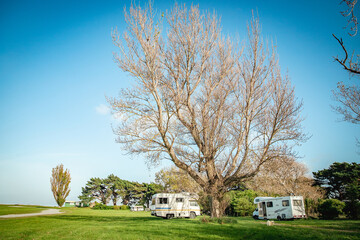 Obraz premium motorhome on a camping ground, caravan vacations, campervan trip