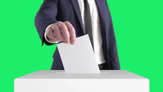 Voting. Man Putting a Ballot into a Voting Box with Chroma Key on Background.