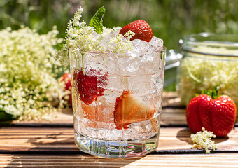 Summer lemonade is made from elderflower cordial and strawberry. A cold refreshing drink in the...
