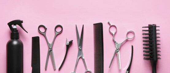 Set with scissors and other hairdresser's accessories on pink background, flat lay. Banner design
