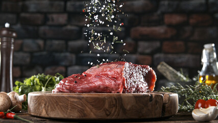 Close-up of falling salt on tasty beef steak in kitchen, freeze motion