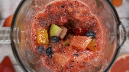 Fresh fruit and vegetables smoothie blended in blender, top view. Healthy eating concept.