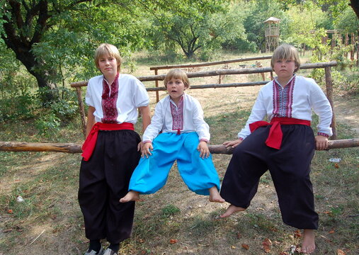 boys in ukrainian embroidery in nature