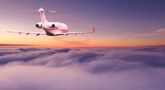 Private airplane jetliner flying above dramatic clouds in beautiful sunset light. Travel concept.