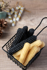 churros sticks typical of Spain with charcoal and vanilla