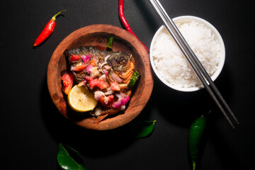 spicy fried fish menu with rice bowl on black background. Asian food photography. good for restaurant menu and poster