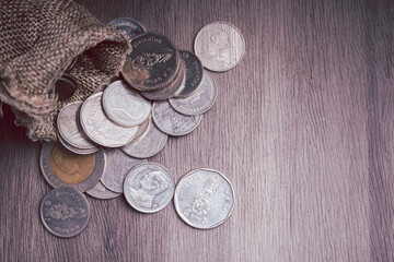Coins in bags piled on the floor. Money saving concept.