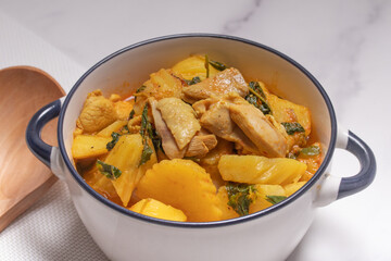 Chicken and Potato Curry with Basil Leaves in a Thai White Bowl