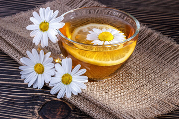 Obraz na płótnie Canvas Herbal tea with chamomile and lemon