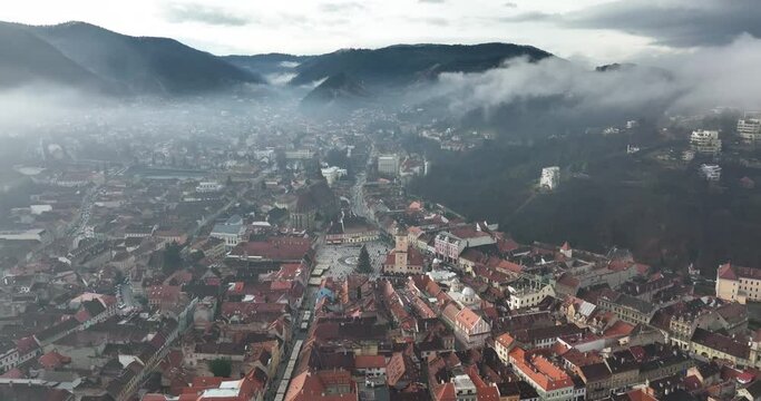 Aerial view of Brasov covered in Fog. Misty morning in Transylvania, Romania