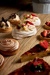 Tartlets with chocolate, strawberry , bundt cakes, on the wood table.
Tasty homemade caramel cheesecake.