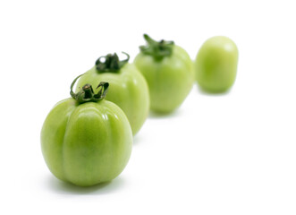 green unripe tomato isolated on white background.