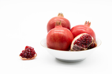 Group of pomegranate closeup isolated on white background.